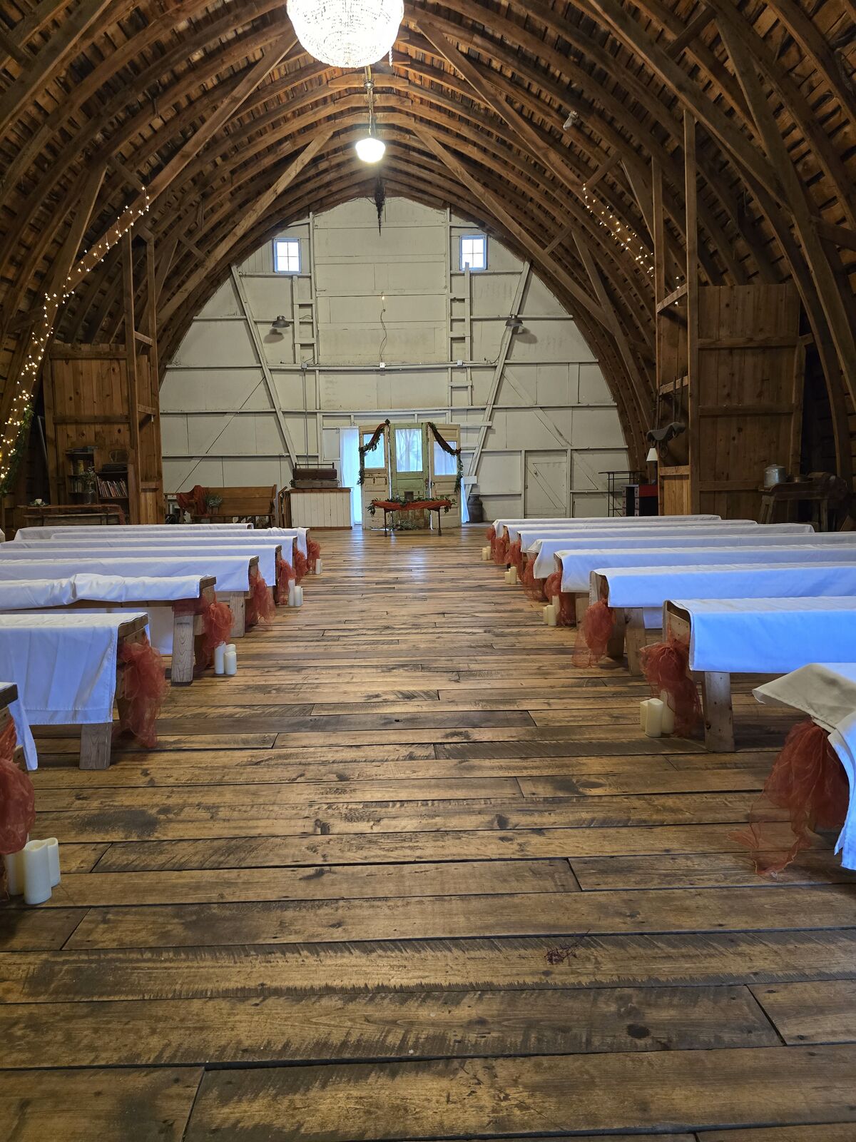 Wedding aisle inside the historic stone barn with wooden beams